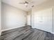 This bedroom offers wood-look floors, a ceiling fan, and a double-door closet at 12524 Garrett Pl, Grand Island, FL 32735