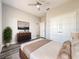 Bedroom boasting a ceiling fan, wood-look floors, and double-door closet at 12524 Garrett Pl, Grand Island, FL 32735