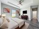 Inviting bedroom featuring tray ceiling, modern decor, and ample space at 12524 Garrett Pl, Grand Island, FL 32735