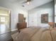 Bedroom featuring wood-look floors, ceiling fan, double closet, and stylish decor at 12524 Garrett Pl, Grand Island, FL 32735