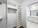 Walk-in closet with custom built-in shelving and access to bathroom at 12524 Garrett Pl, Grand Island, FL 32735