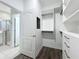 Walk-in closet with custom built-in shelving and access to bathroom at 12524 Garrett Pl, Grand Island, FL 32735