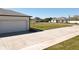 Long driveway and garage create curb appeal on a manicured lawn in quiet neighborhood at 12524 Garrett Pl, Grand Island, FL 32735