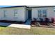Home exterior features a well-kept lawn and walkway leading to the front door at 12524 Garrett Pl, Grand Island, FL 32735