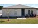 Front exterior with well-maintained lawn, walkway to the entrance, and decorative landscaping at 12524 Garrett Pl, Grand Island, FL 32735