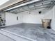 Spacious two car garage featuring high ceilings, access door, and electrical panel at 12524 Garrett Pl, Grand Island, FL 32735