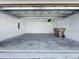 View of the two car garage featuring high ceilings, access door, and electrical panel at 12524 Garrett Pl, Grand Island, FL 32735