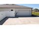 Spacious driveway leads to a two-car garage, enhanced by a secure, gated fence at 12524 Garrett Pl, Grand Island, FL 32735
