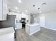 Spacious kitchen featuring white cabinetry, stainless steel appliances, and an island with a sink at 12524 Garrett Pl, Grand Island, FL 32735