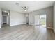 Spacious living area with sliding glass doors, a ceiling fan, and neutral wall color at 12524 Garrett Pl, Grand Island, FL 32735
