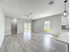 Open concept living room with plenty of natural light and sliding glass doors to the patio at 12524 Garrett Pl, Grand Island, FL 32735