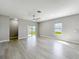Bright, open-plan living area with sliding glass doors leading to the outdoor space at 12524 Garrett Pl, Grand Island, FL 32735