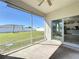 View from screened porch into the home's kitchen and backyard featuring a swing set at 12524 Garrett Pl, Grand Island, FL 32735