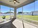 Relaxing screened porch with ceiling fan overlooking a large, fenced backyard at 12524 Garrett Pl, Grand Island, FL 32735
