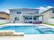 Gorgeous backyard showcasing a sparkling pool, covered patio, and well-maintained landscaping at 12627 Boggy Pointe Dr, Orlando, FL 32824