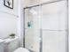 Clean bathroom with a modern toilet and glass-enclosed shower at 12627 Boggy Pointe Dr, Orlando, FL 32824