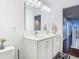 Bright bathroom featuring double sinks with modern fixtures and decorative accents at 12627 Boggy Pointe Dr, Orlando, FL 32824