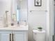 Clean bathroom with a modern vanity, mirror, and toilet with stylish decor at 12627 Boggy Pointe Dr, Orlando, FL 32824