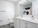 Well-lit bathroom featuring double sinks with white cabinets and modern fixtures at 12627 Boggy Pointe Dr, Orlando, FL 32824
