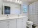 Bathroom featuring double sinks with stylish fixtures and a modern shower curtain at 12627 Boggy Pointe Dr, Orlando, FL 32824