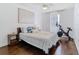 Cozy bedroom with hardwood flooring, ceiling fan, and modern artwork at 12627 Boggy Pointe Dr, Orlando, FL 32824