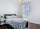 Comfortable bedroom features a bed with a stylish duvet, hardwood floors, and a window at 12627 Boggy Pointe Dr, Orlando, FL 32824