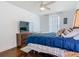 Bedroom featuring a comfortable bed, TV, ceiling fan, and modern decor at 12627 Boggy Pointe Dr, Orlando, FL 32824