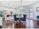 Dining area features a modern chandelier and open concept view into the kitchen at 12627 Boggy Pointe Dr, Orlando, FL 32824