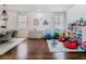 Dining room with modern chandelier, hardwood floors, and connected playroom, offering a versatile living space at 12627 Boggy Pointe Dr, Orlando, FL 32824