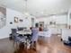 Elegant dining area with modern chandelier, hardwood floors, and an open view to the kitchen at 12627 Boggy Pointe Dr, Orlando, FL 32824