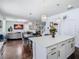 Open kitchen with white cabinetry, quartz countertops, stainless appliances and open to living area at 12627 Boggy Pointe Dr, Orlando, FL 32824