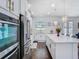 Bright kitchen featuring white cabinetry, stainless steel appliances and an island bar at 12627 Boggy Pointe Dr, Orlando, FL 32824