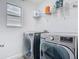 Laundry room featuring modern washer and dryer units with shelving at 12627 Boggy Pointe Dr, Orlando, FL 32824