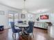 Open-concept living room with modern finishes, hardwood floors and view to the outdoor pool area at 12627 Boggy Pointe Dr, Orlando, FL 32824