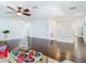 Large living room with hardwood floors and a ceiling fan at 12627 Boggy Pointe Dr, Orlando, FL 32824