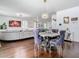Open-concept living room with modern finishes, hardwood floors, grey couches and stairway access at 12627 Boggy Pointe Dr, Orlando, FL 32824