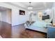 Well-lit main bedroom featuring hardwood floors, a decorative ceiling light, and calming neutral tones at 12627 Boggy Pointe Dr, Orlando, FL 32824