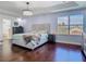 Bright main bedroom showcasing a large window, hardwood floors, and a tray ceiling with chandelier at 12627 Boggy Pointe Dr, Orlando, FL 32824