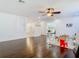 Spacious playroom with hardwood floors, neutral walls and a ceiling fan, perfect for various activities at 12627 Boggy Pointe Dr, Orlando, FL 32824