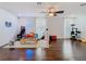 Bright playroom featuring hardwood floors, a ceiling fan, and playful decor; a perfect space for children at 12627 Boggy Pointe Dr, Orlando, FL 32824