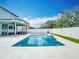 Relaxing pool area with white tile and a covered patio, perfect for outdoor entertainment at 12627 Boggy Pointe Dr, Orlando, FL 32824