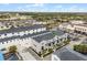Desirable townhome with gray exterior, a well-kept landscape, and attached garages near shopping at 13042 Michael Callin Aly, Orlando, FL 32828