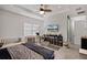 Bedroom featuring a tray ceiling, ceiling fan, and a TV on the wall at 13042 Michael Callin Aly, Orlando, FL 32828