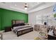 Bedroom featuring a tray ceiling, ceiling fan, and an accent wall at 13042 Michael Callin Aly, Orlando, FL 32828