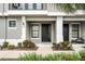 Townhome entrance with well-maintained landscaping at 13042 Michael Callin Aly, Orlando, FL 32828