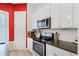 Well-equipped kitchen with modern oven and microwave at 13042 Michael Callin Aly, Orlando, FL 32828