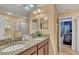 Bathroom with a double vanity, granite countertops, and a glass-enclosed shower at 1454 Belle Terre Rd, Davenport, FL 33896