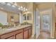 Bathroom featuring double sink vanity, granite countertop, and bright lighting at 1454 Belle Terre Rd, Davenport, FL 33896
