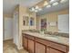 Bathroom with a double sink vanity, granite countertop, and a large mirror at 1454 Belle Terre Rd, Davenport, FL 33896