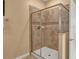 Tiled shower room with glass door enclosure, tiled walls, and tiled flooring at 1454 Belle Terre Rd, Davenport, FL 33896